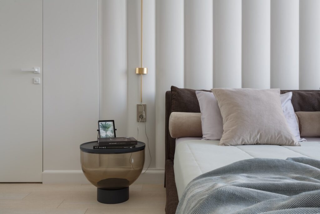 minimal bedroom with glass nightstand