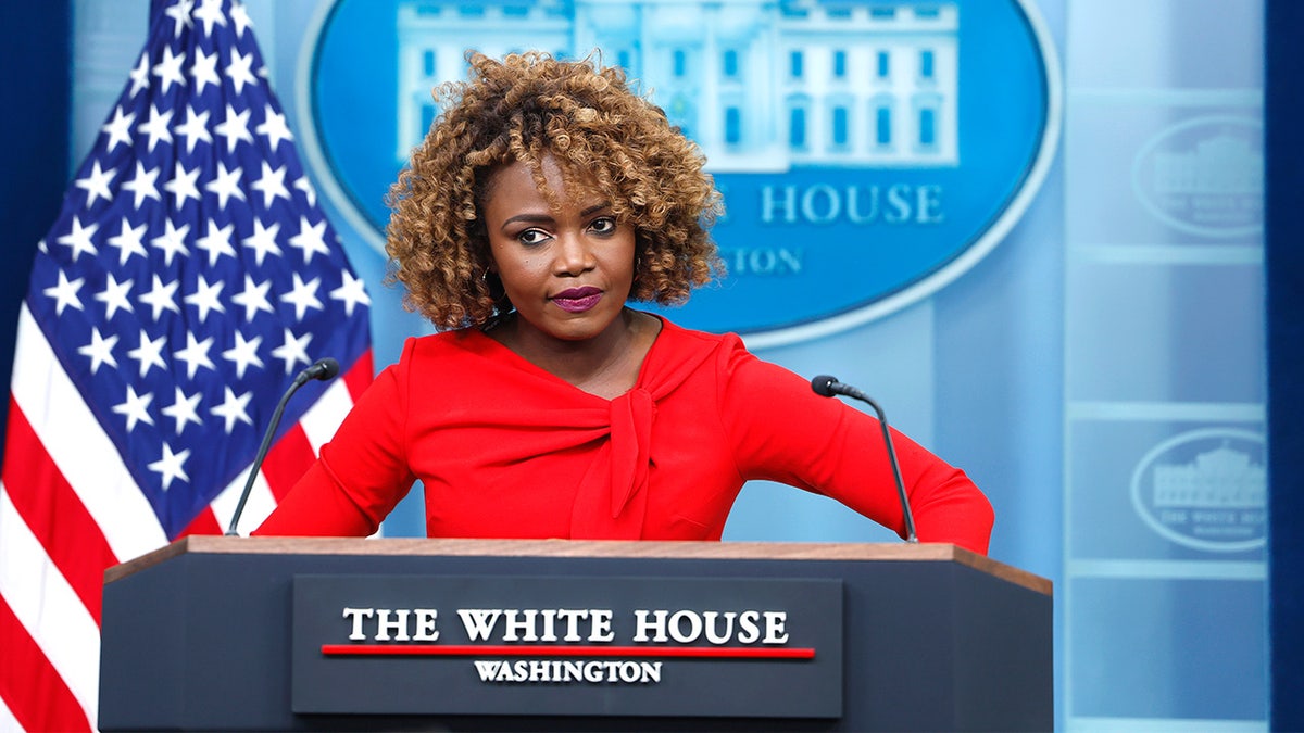 Karine Jean-Pierre speaking at the White House press briefing podium.
